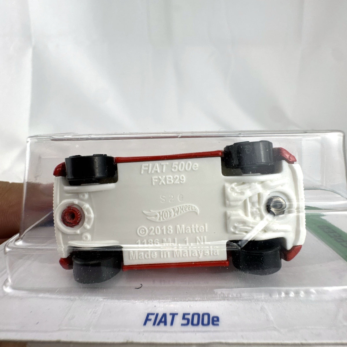 Hot Wheels 1:64 scale FIAT 500e diecast car in red on sealed HW Green Speed blister cardback.