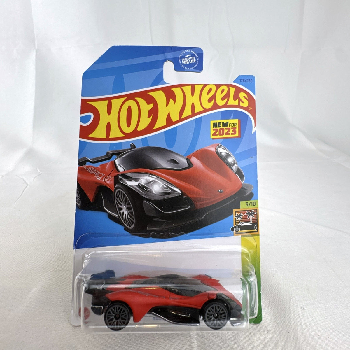 Sealed red Hot Wheels Celero GT 1:64 diecast car on original 2023 HW Exotics cardback
