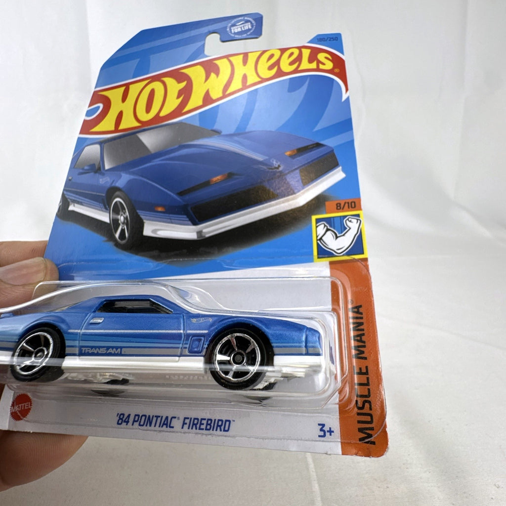 Hot Wheels 1:64 scale 1984 Pontiac Firebird Trans Am in metallic blue, factory sealed on original card.
