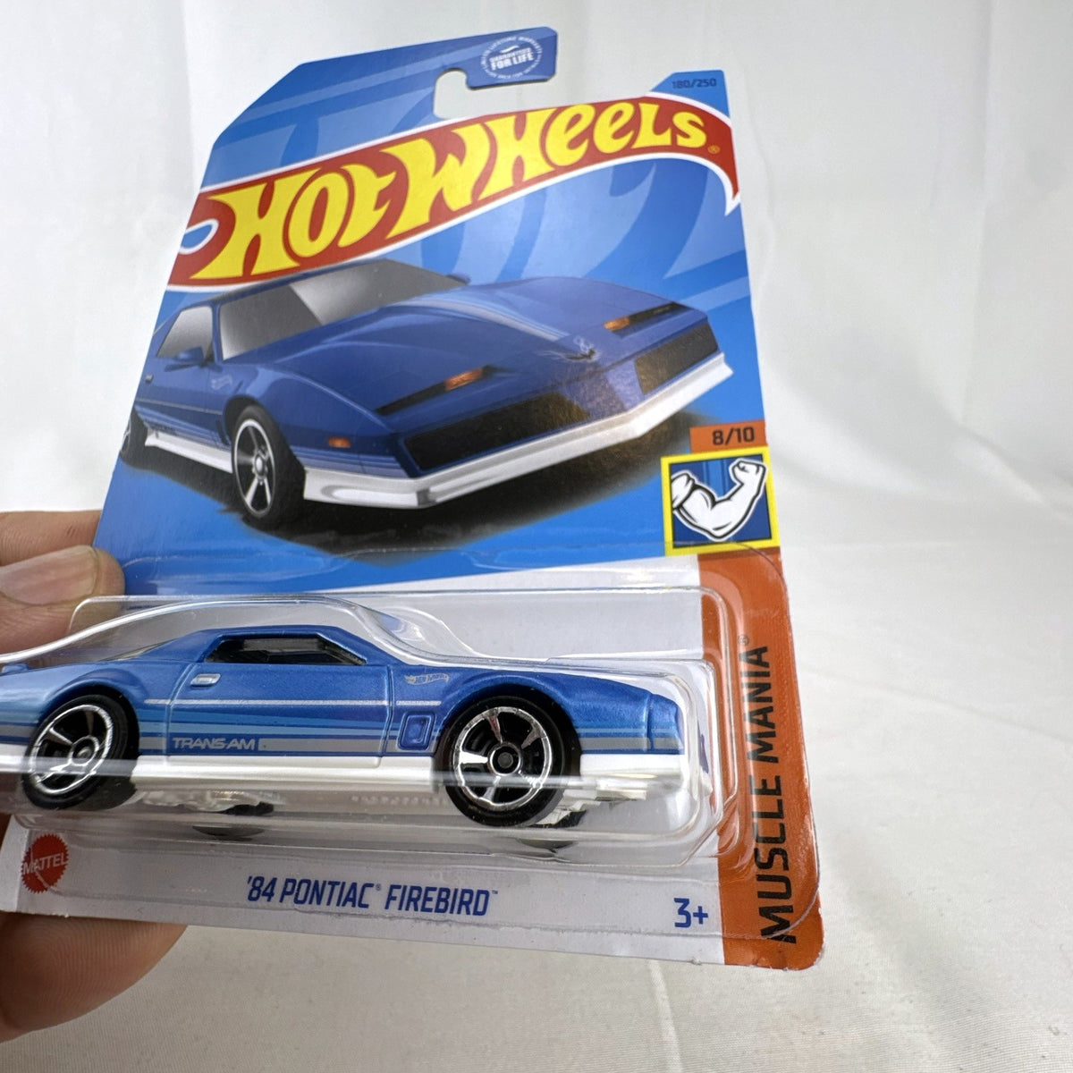 Hot Wheels 1:64 scale 1984 Pontiac Firebird Trans Am in metallic blue, factory sealed on original card.