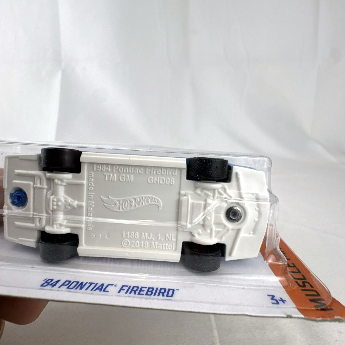 Hot Wheels 1:64 scale 1984 Pontiac Firebird Trans Am in metallic blue, factory sealed on original card.