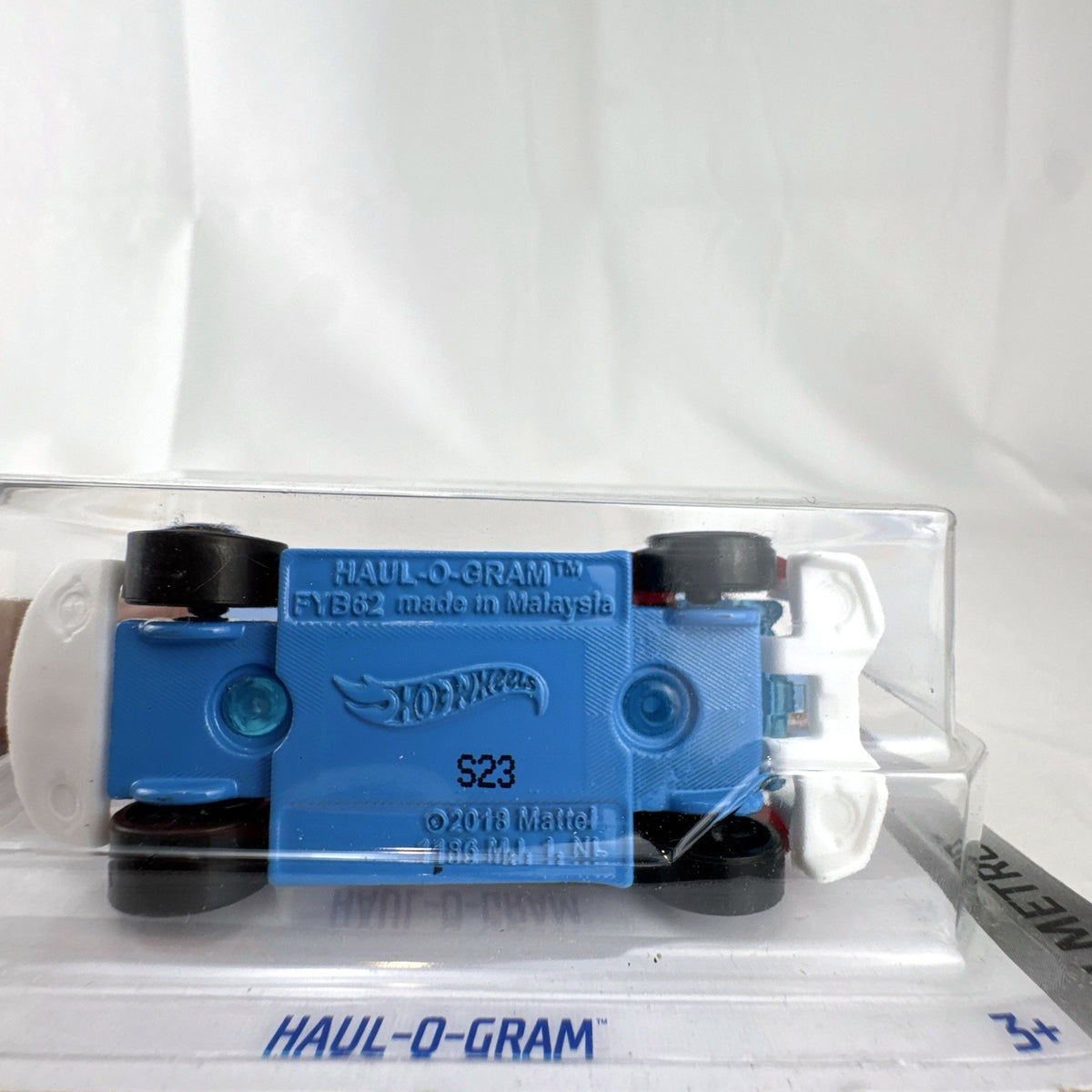 Hot Wheels Haul-O-Gram 1:64 scale translucent red diecast truck factory sealed in blister pack