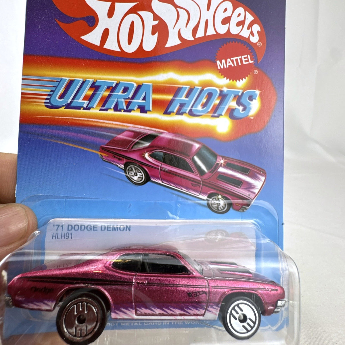 Hot Wheels 1:64 scale 1971 Dodge Demon diecast car in Spectraflame pink Ultra Hots sealed packaging.