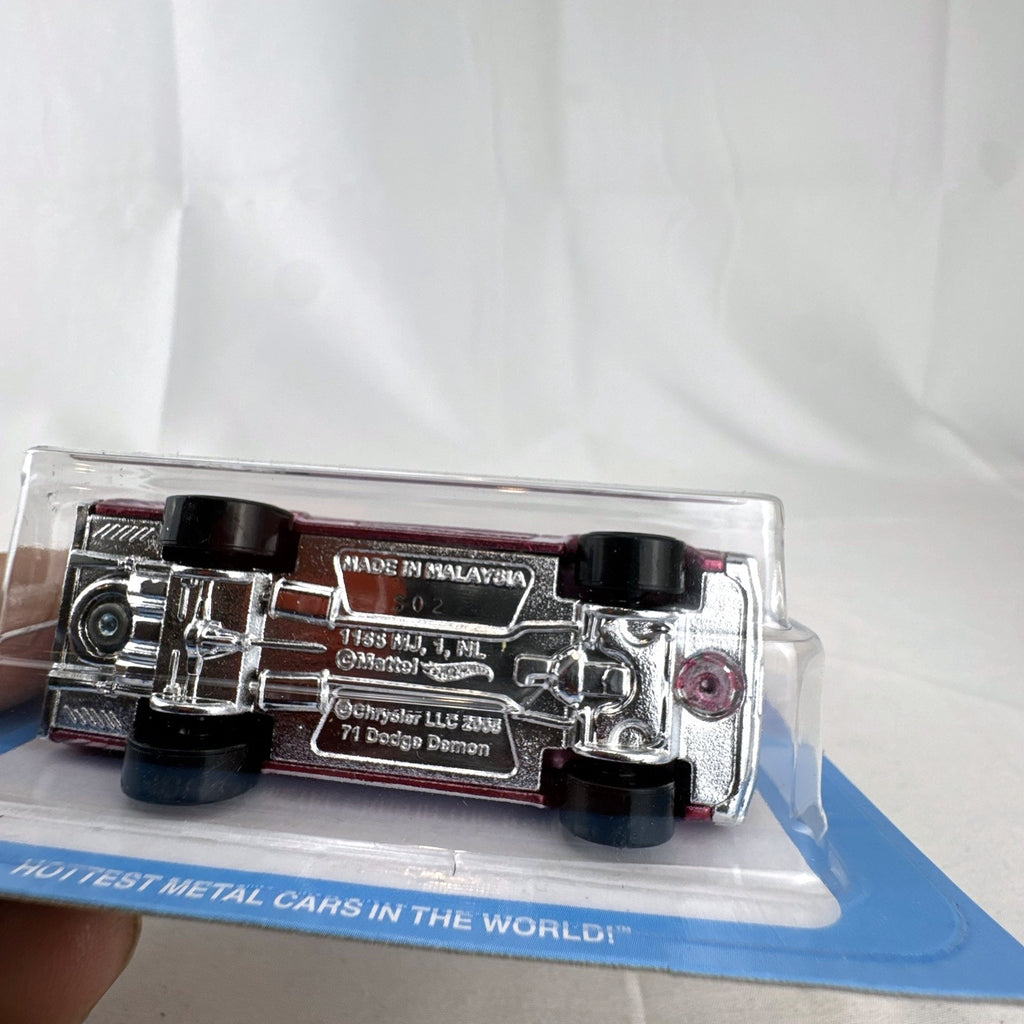 Hot Wheels 1:64 scale 1971 Dodge Demon diecast car in Spectraflame pink Ultra Hots sealed packaging.