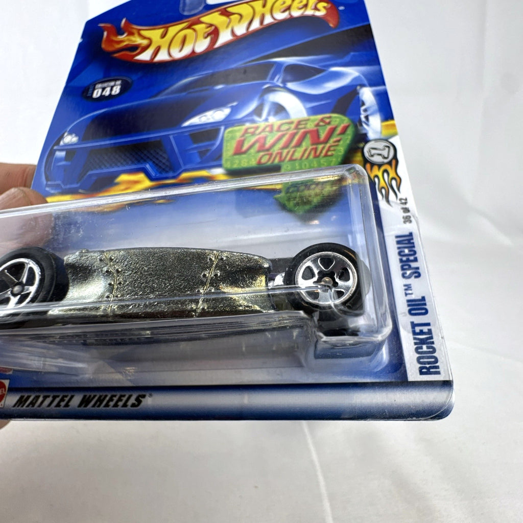 Hot Wheels 2002 First Editions Rocket Oil Special 1:64 scale diecast car in deep purple with chrome chassis, sealed in package.