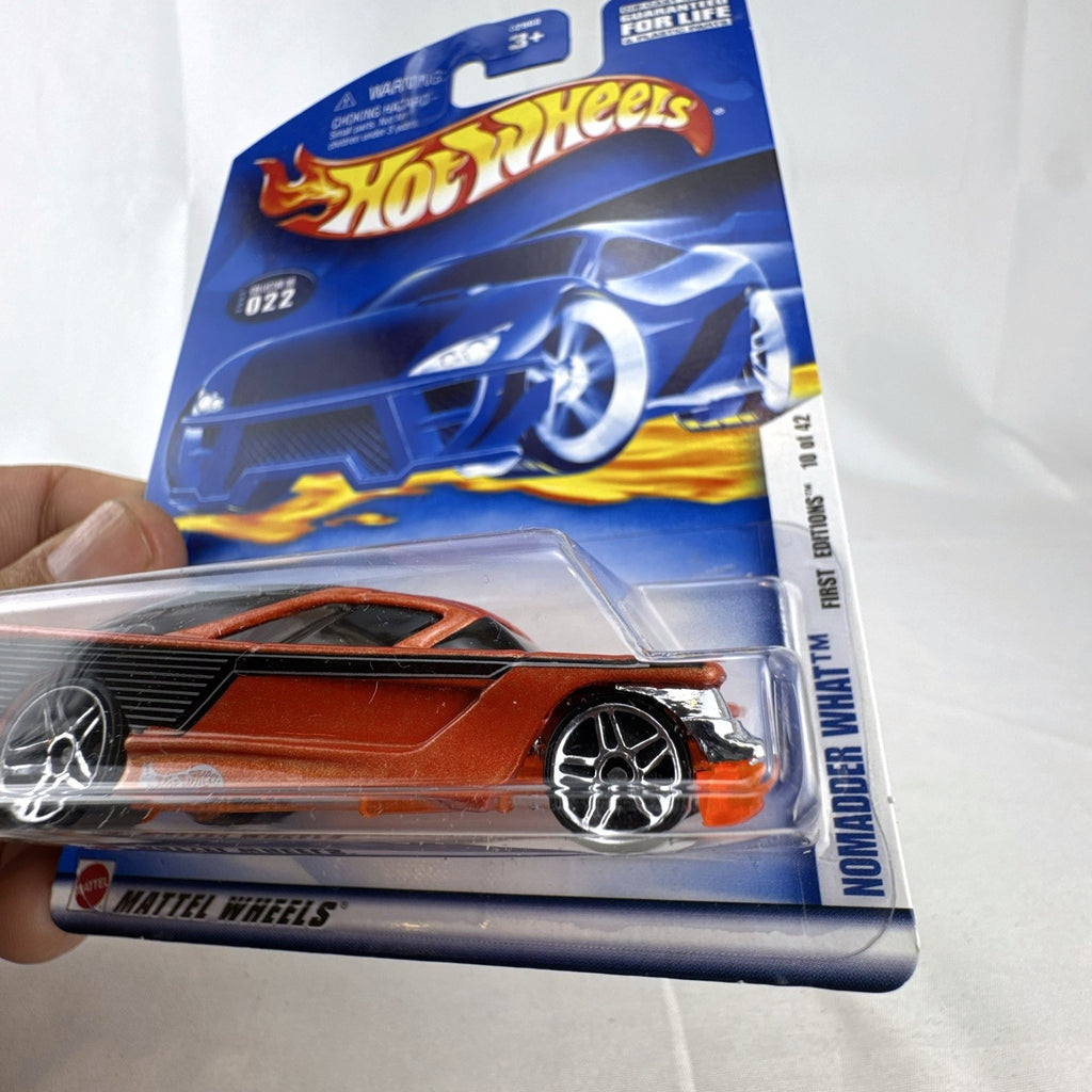Hot Wheels 2002 First Editions Nomadder What 1:64 scale diecast car in metallic orange, sealed on original card package.