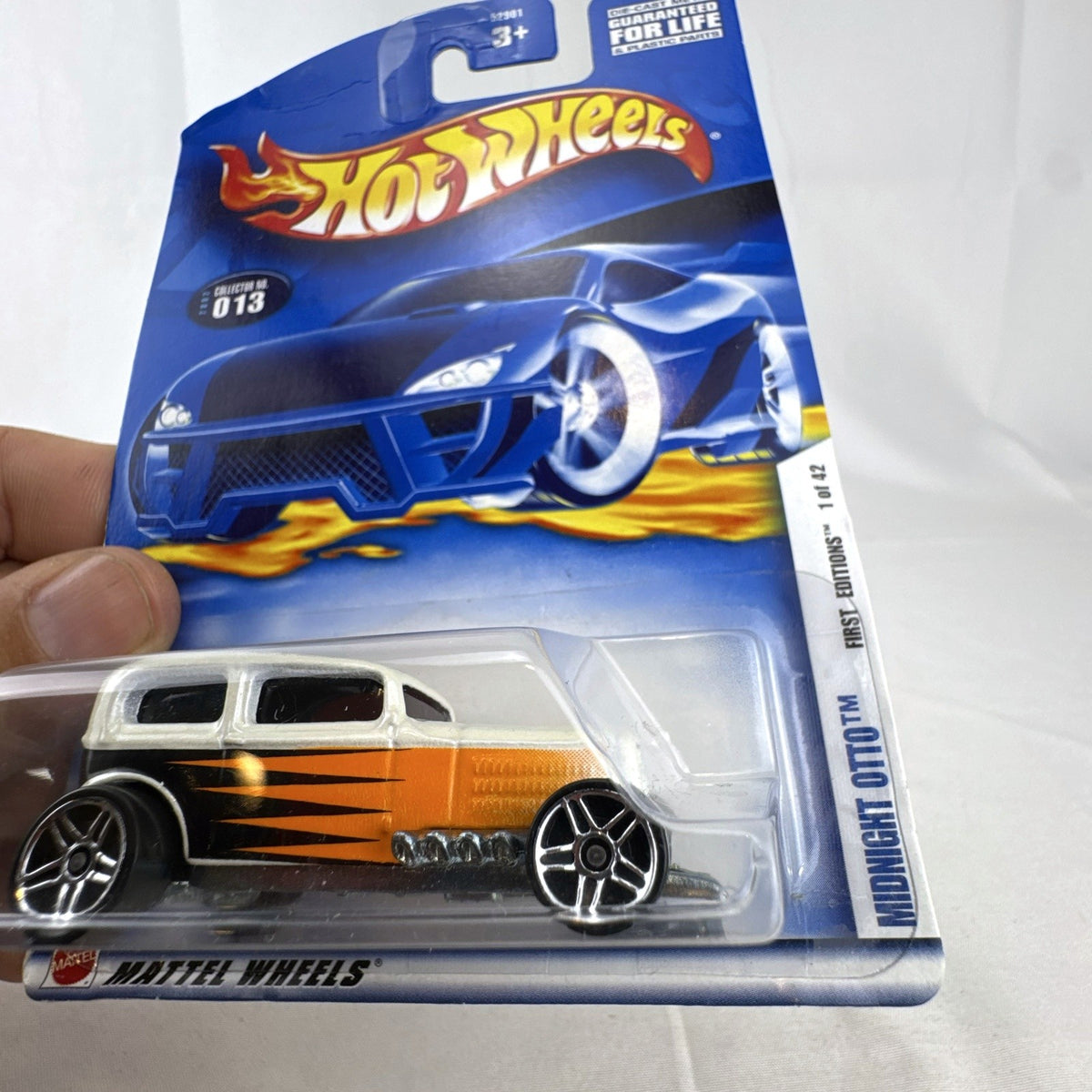 Hot Wheels 2002 Midnight Otto 1:64 scale diecast car in original packaging with pearl white, orange, and black flame graphics