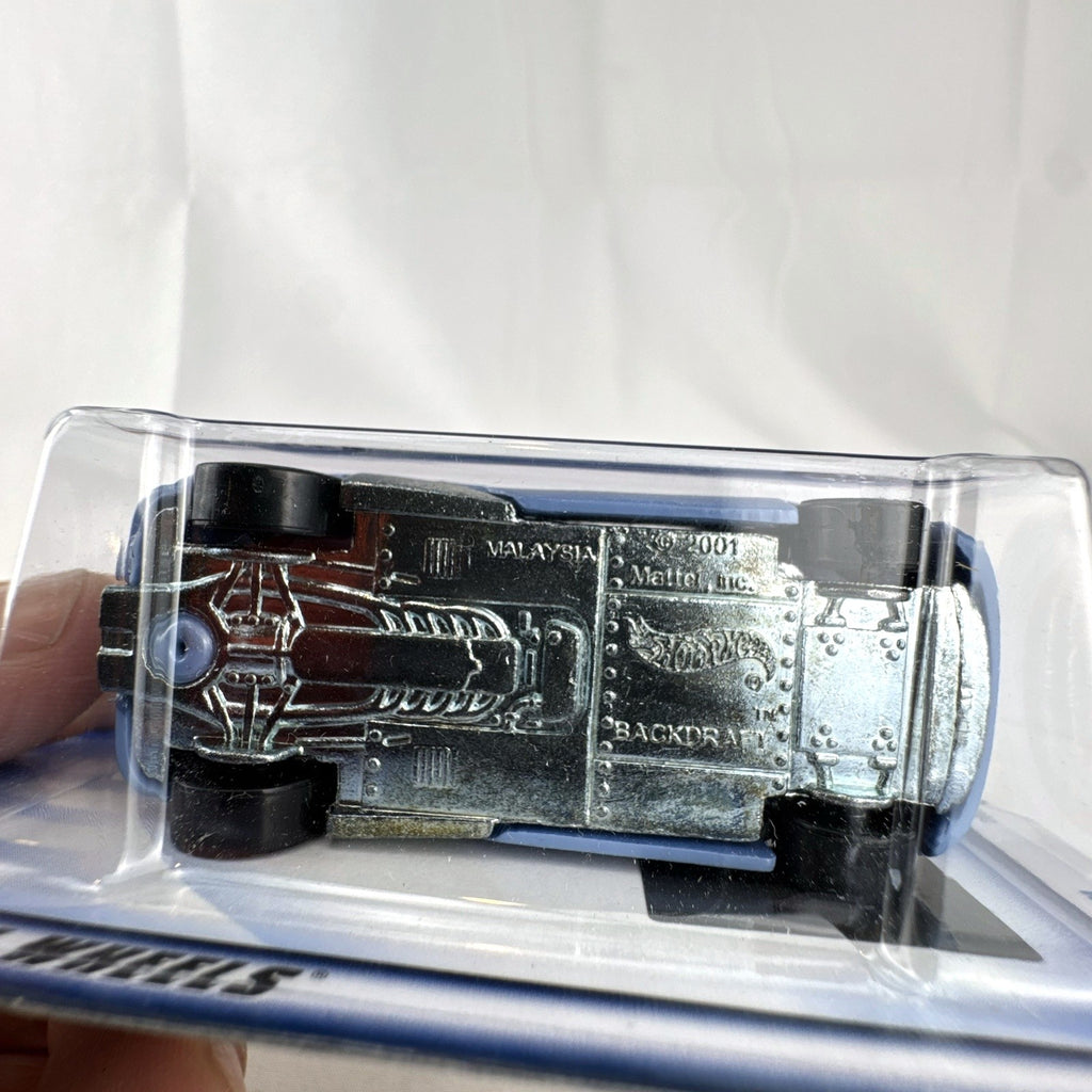 Sealed 2002 Hot Wheels First Editions Backdraft diecast car in metallic blue on original card package.