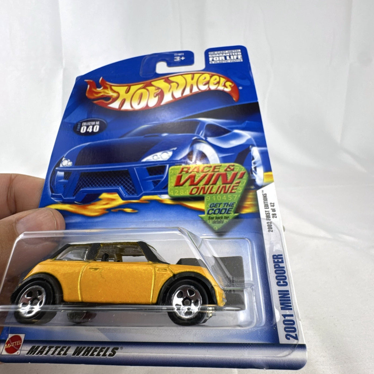 Hot Wheels 2002 First Editions 2001 Mini Cooper diecast car in yellow with white roof, sealed on card