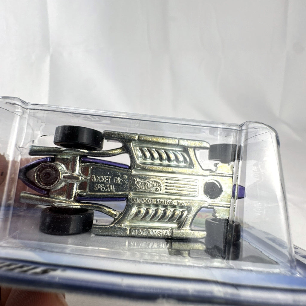 Hot Wheels 2002 First Editions Rocket Oil Special 1:64 scale diecast car in metallic purple, sealed on card.