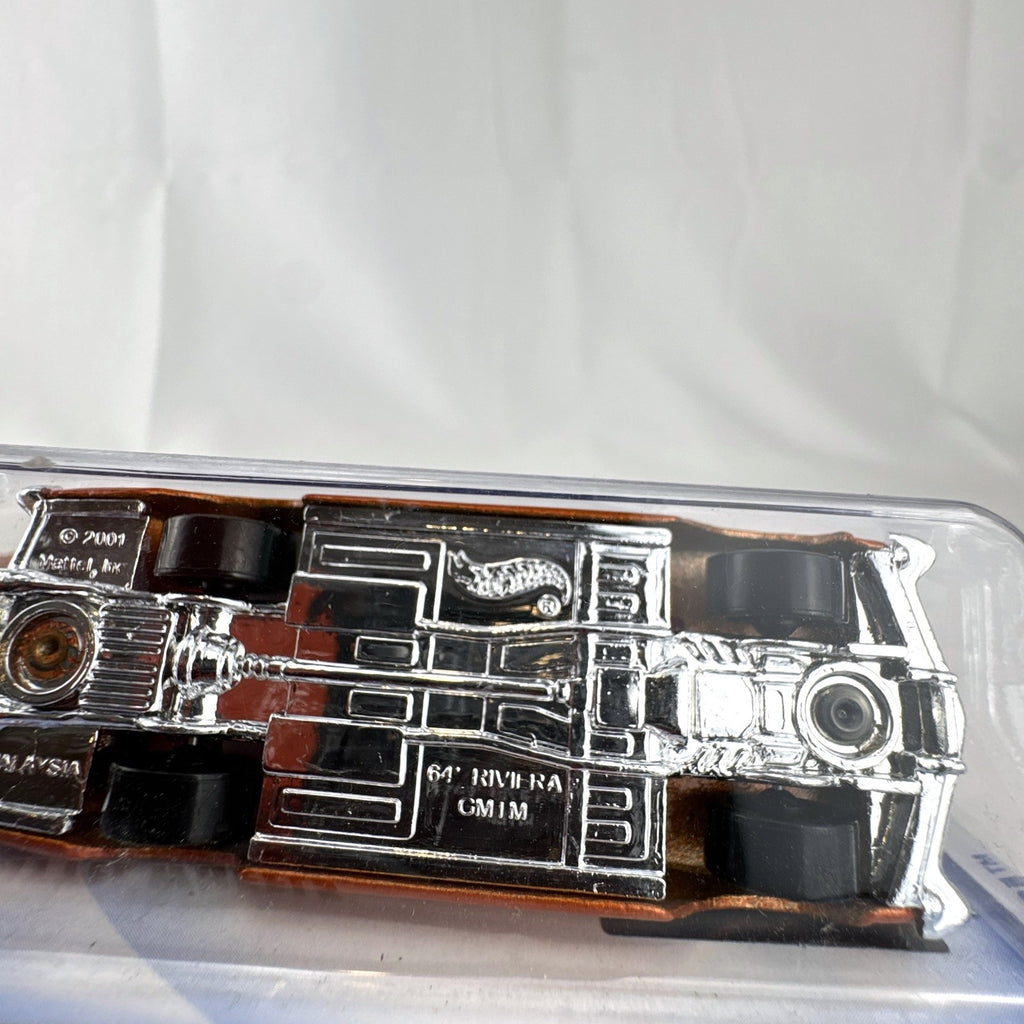 Sealed 2002 Hot Wheels First Editions 1964 Buick Riviera diecast car in metallic orange on blister card.