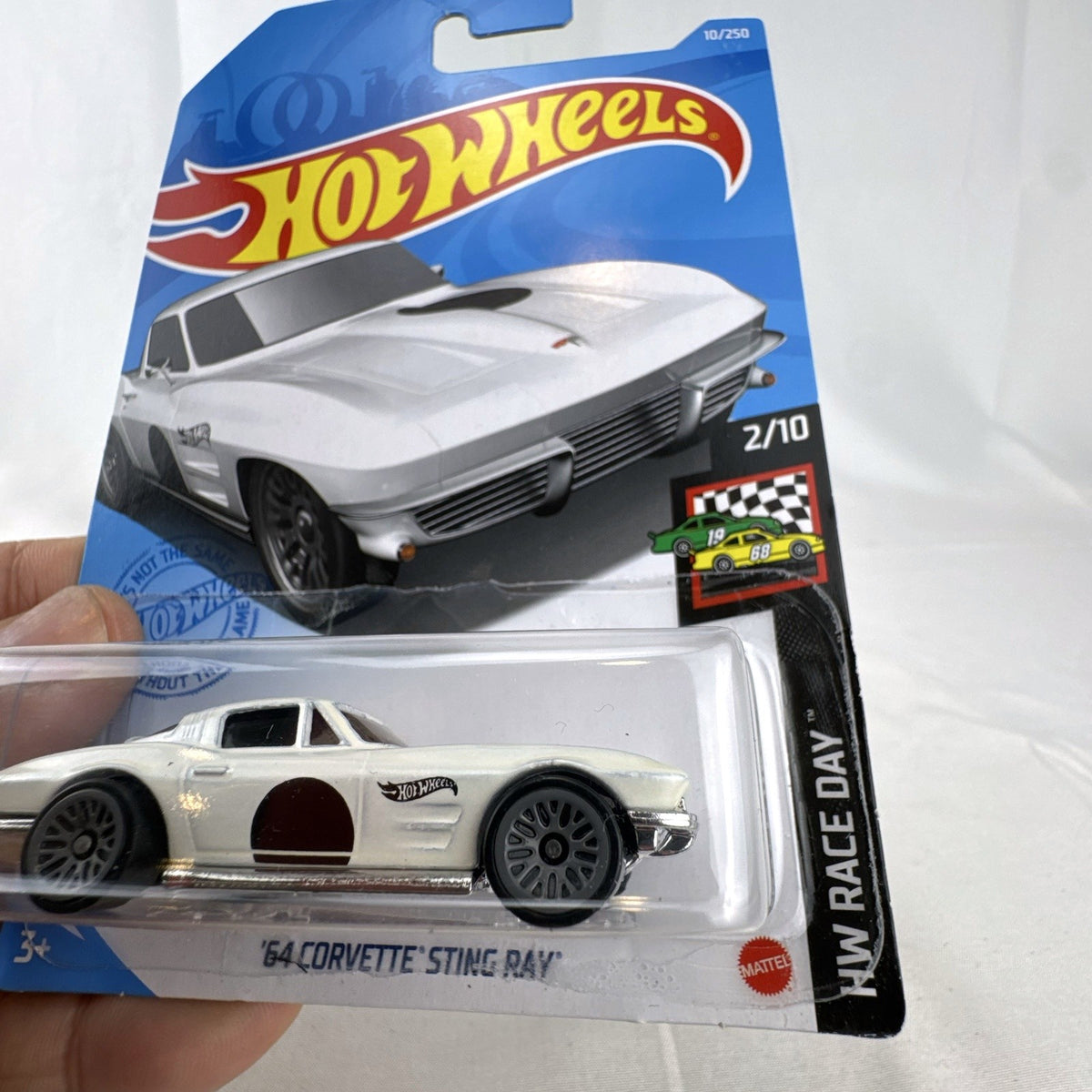 Hot Wheels 1:64 1964 Chevrolet Corvette Sting Ray in white from the HW Race Day series, factory sealed on blister card.