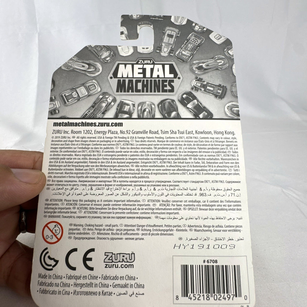 Zuru Metal Machines Scorpio 1:64 scale diecast car in factory sealed packaging, featuring dark gray and orange styling.
