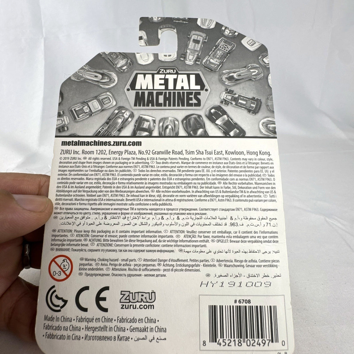 Zuru Metal Machines Scorpio 1:64 scale diecast car in factory sealed packaging, featuring dark gray and orange styling.