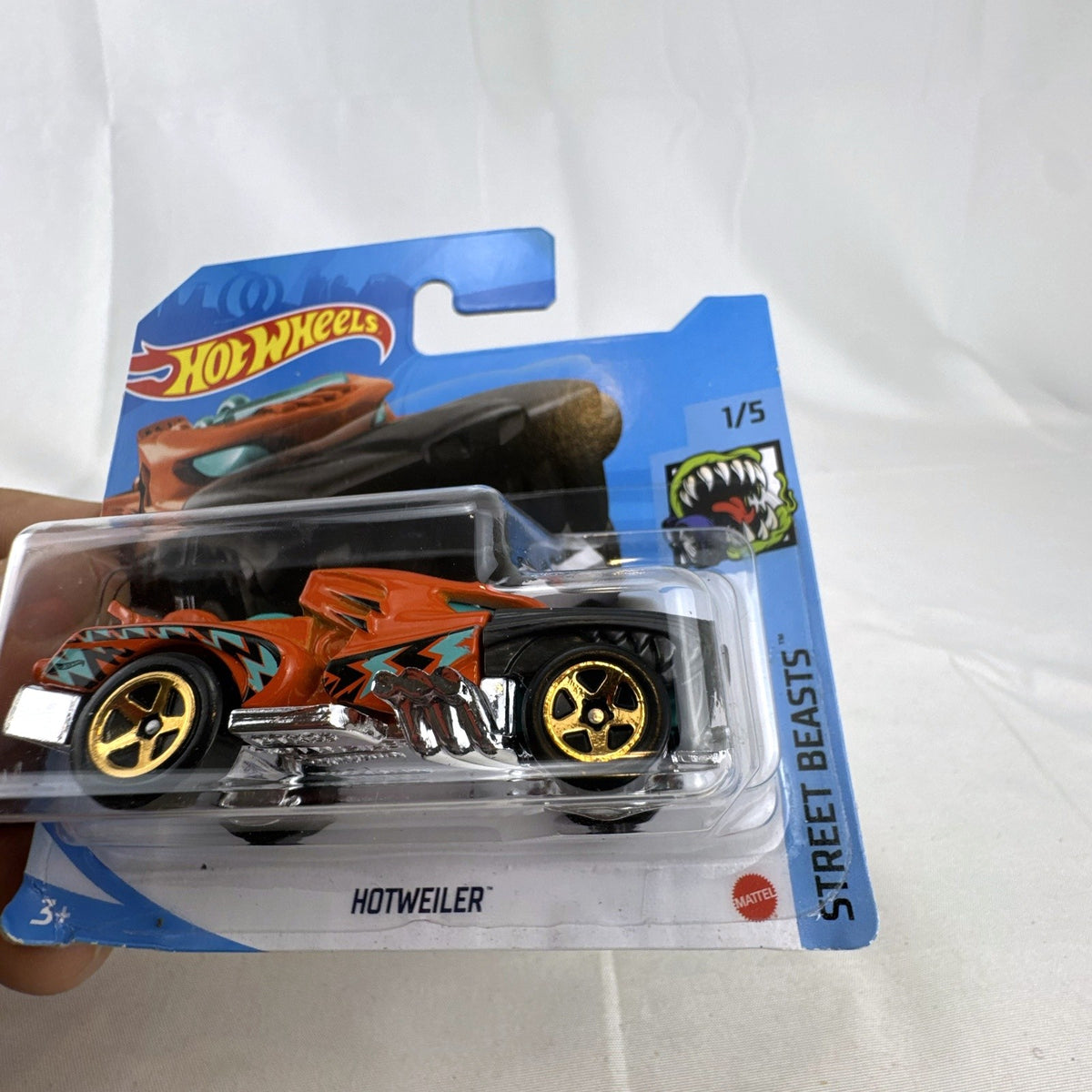 Hot Wheels Hotweiler 1:64 diecast car in orange and black, unopened on 2021 Street Beasts cardback.