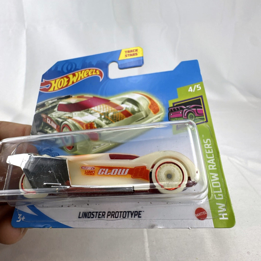 Hot Wheels 1:64 Lindster Prototype diecast car sealed on card in HW Glow Racers glow-in-the-dark white finish.