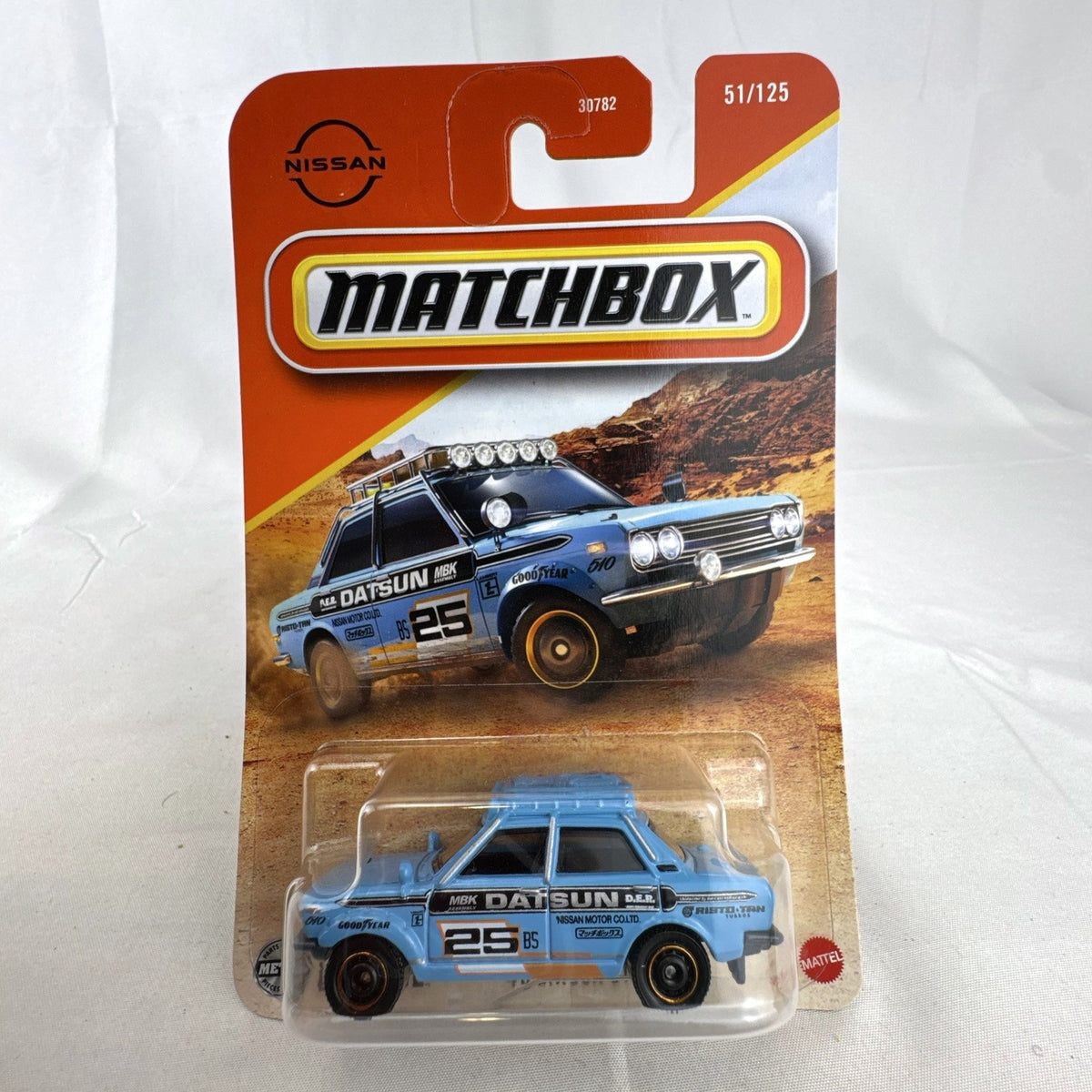 Factory sealed Matchbox 1970 Datsun 510 Rally 1:64 scale diecast car in light blue on original card packaging.