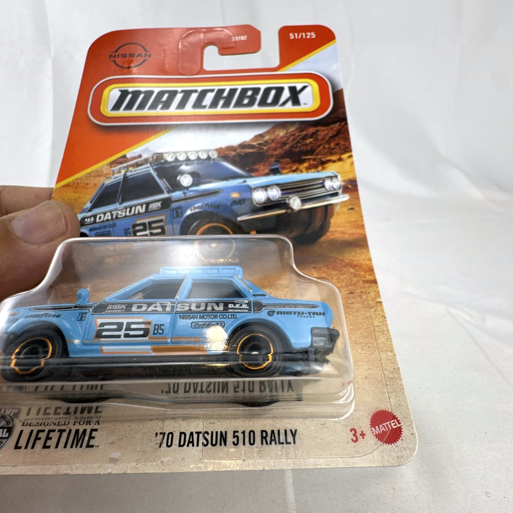 Factory sealed Matchbox 1970 Datsun 510 Rally 1:64 scale diecast car in light blue on original card packaging.