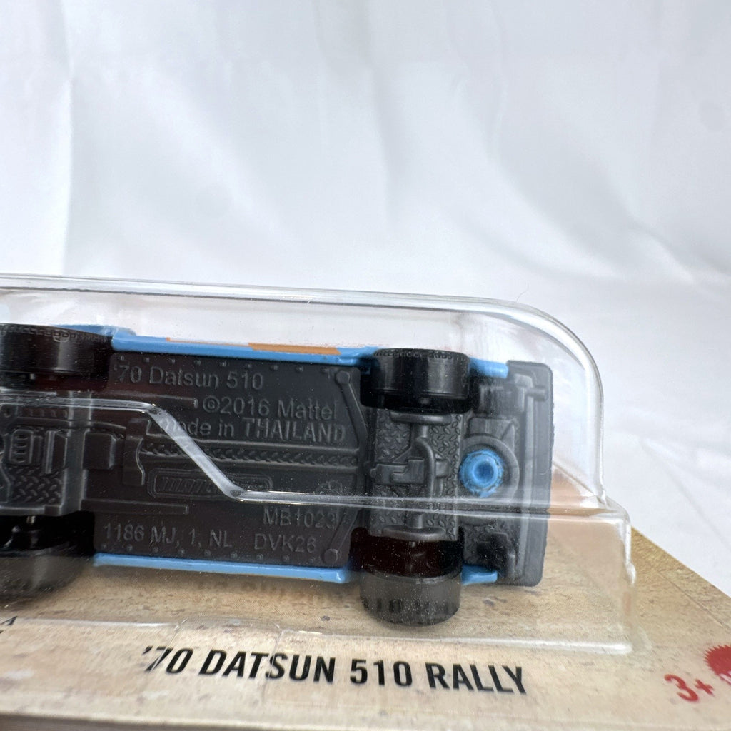 Factory sealed Matchbox 1970 Datsun 510 Rally 1:64 scale diecast car in light blue on original card packaging.