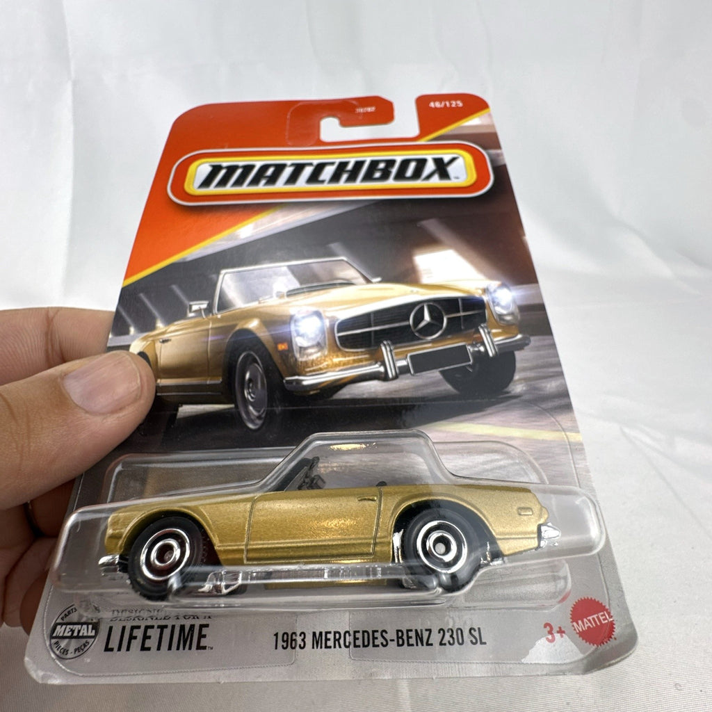 Matchbox 1:64 scale 1963 Mercedes-Benz 230 SL diecast model car in metallic gold on original unopened blister card.