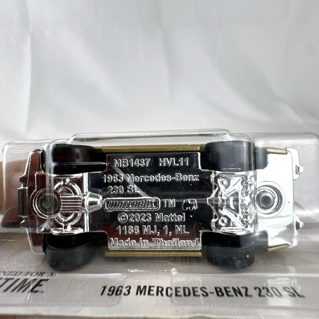 Matchbox 1:64 scale 1963 Mercedes-Benz 230 SL diecast model car in metallic gold on original unopened blister card.
