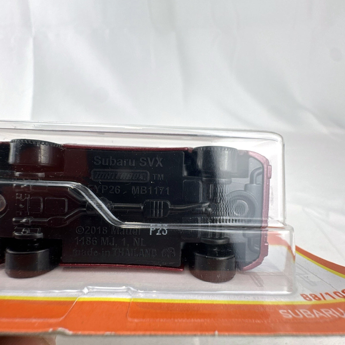 Matchbox 1:64 Subaru SVX diecast model car in metallic maroon designed by Ryu Asada