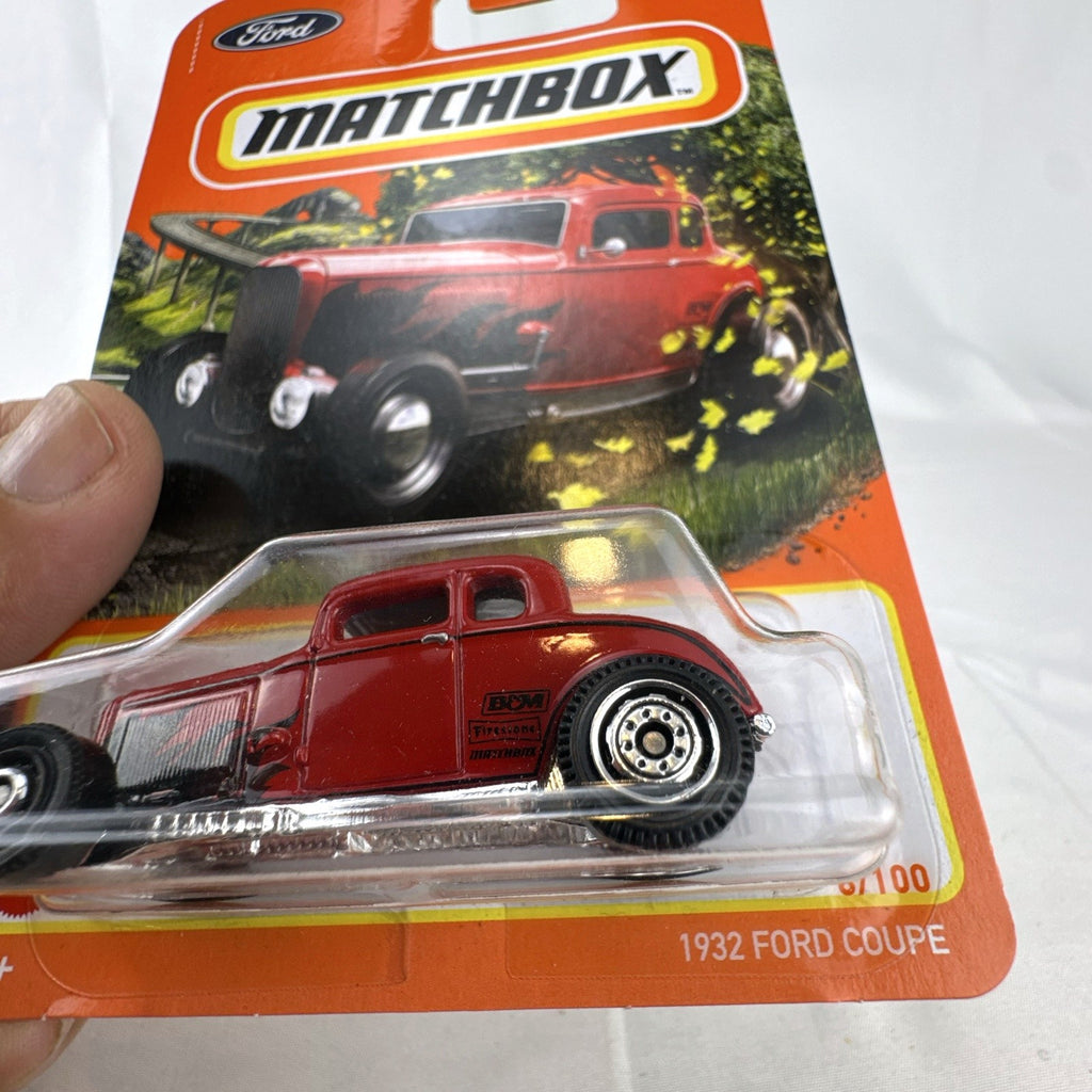 Matchbox 1:64 scale 1932 Ford Coupe Model B diecast car in red with black flame graphics sealed on card