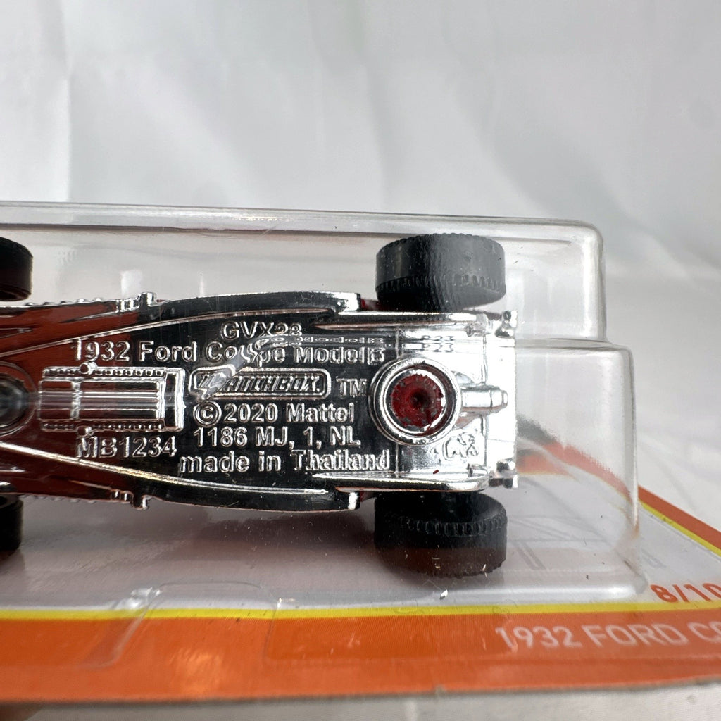 Matchbox 1:64 scale 1932 Ford Coupe Model B diecast car in red with black flame graphics sealed on card