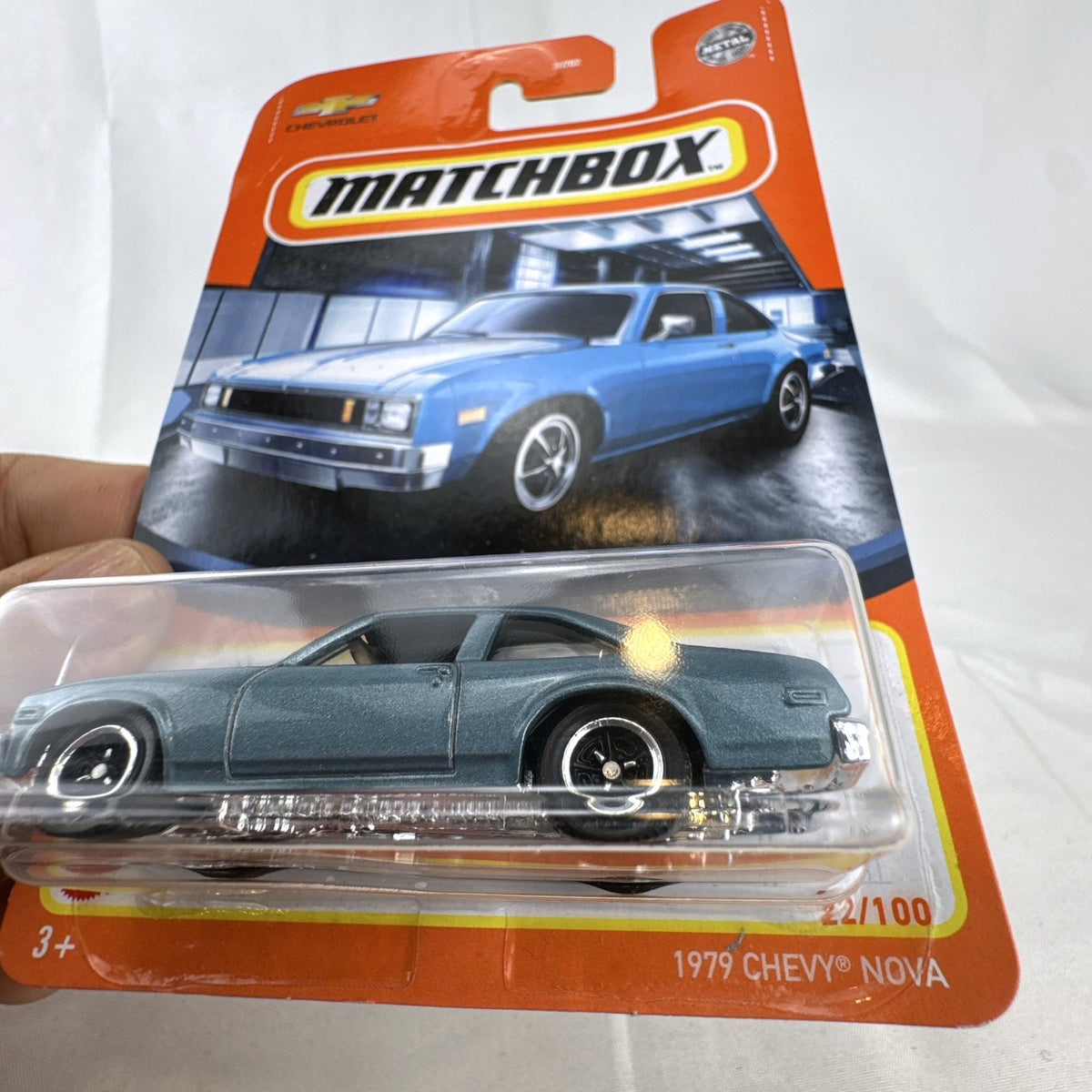 Matchbox 1:64 scale 1979 Chevrolet Nova diecast model car in metallic blue, sealed on original card.