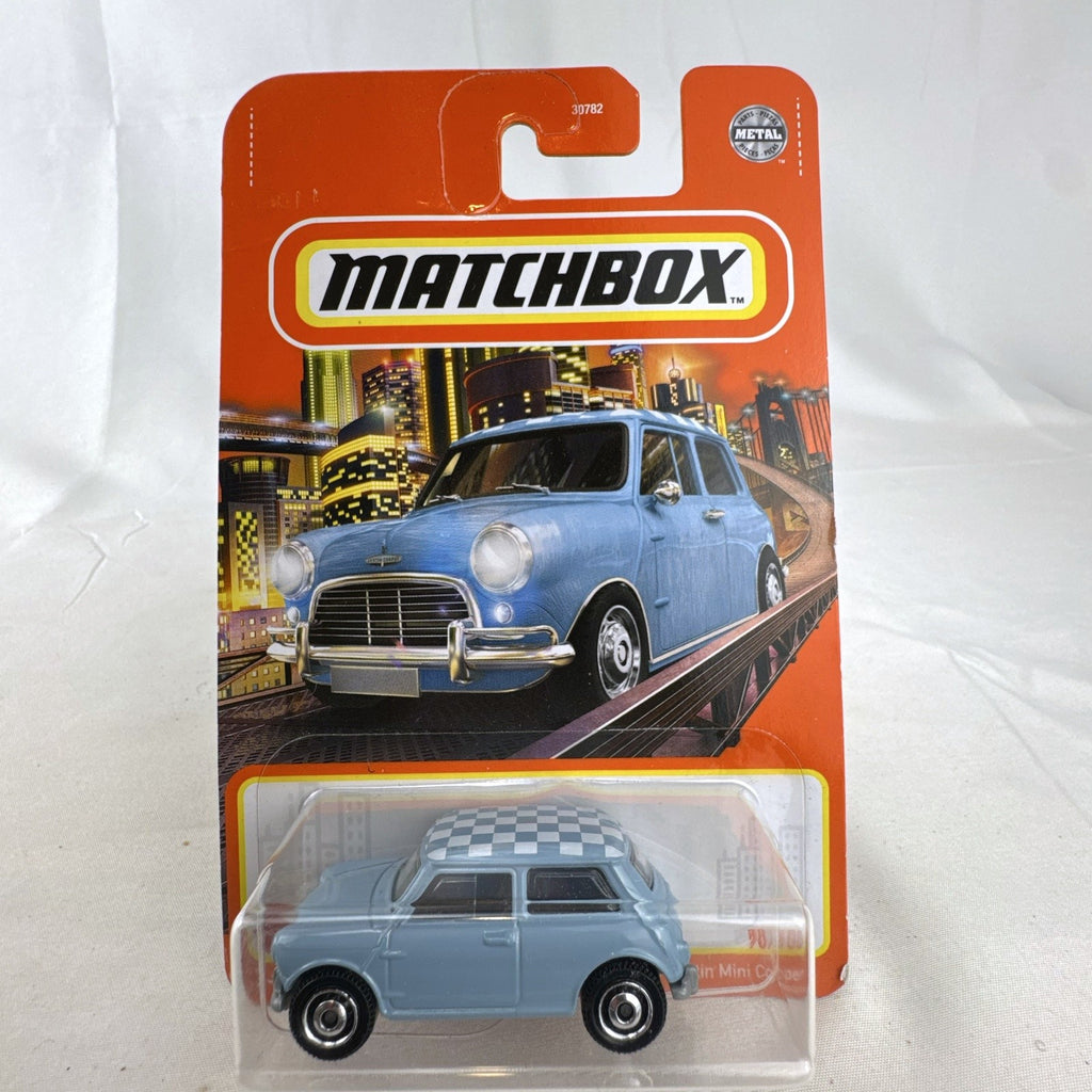 Matchbox 1:64 scale 1964 Austin Mini Cooper 1275S diecast car in light blue with checkered roof on original card