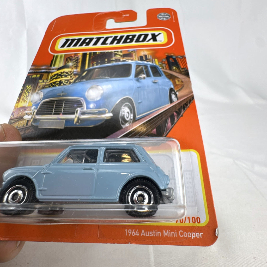 Matchbox 1:64 scale 1964 Austin Mini Cooper 1275S diecast car in light blue with checkered roof on original card