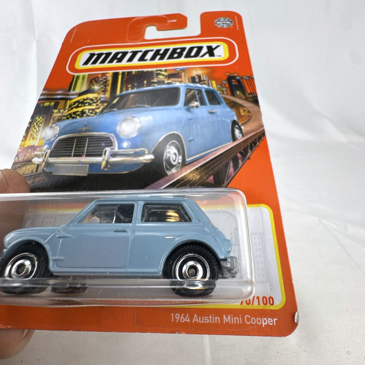 Matchbox 1:64 scale 1964 Austin Mini Cooper 1275S diecast car in light blue with checkered roof on original card