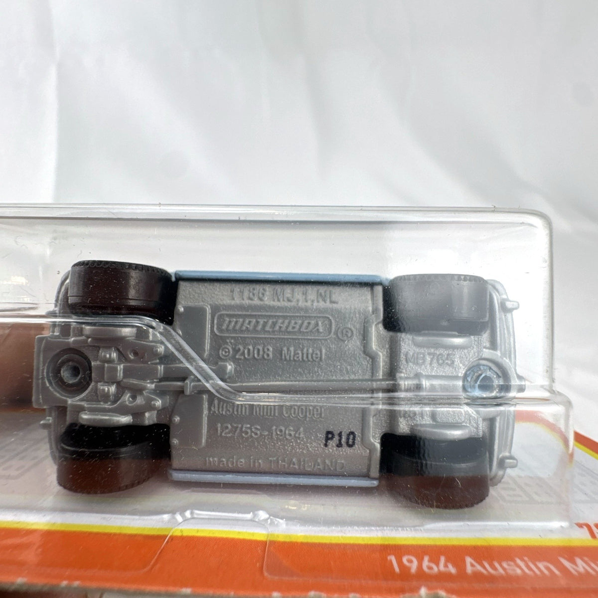 Matchbox 1:64 scale 1964 Austin Mini Cooper 1275S diecast car in light blue with checkered roof on original card