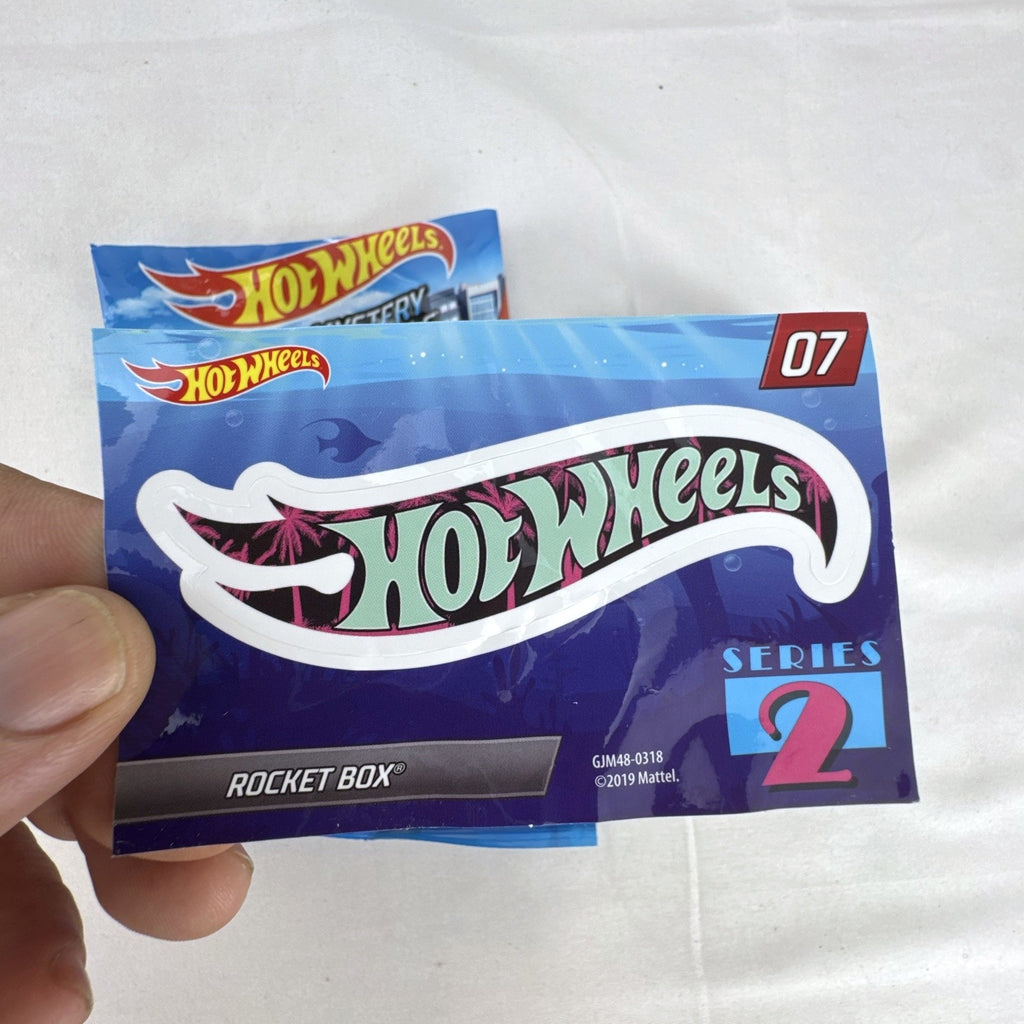 Hot Wheels Rocket Box #07 diecast car in black with pink and teal graphics from Mystery Models Series 2