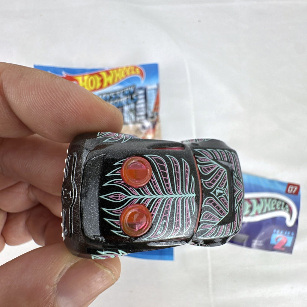 Hot Wheels Rocket Box #07 diecast car in black with pink and teal graphics from Mystery Models Series 2