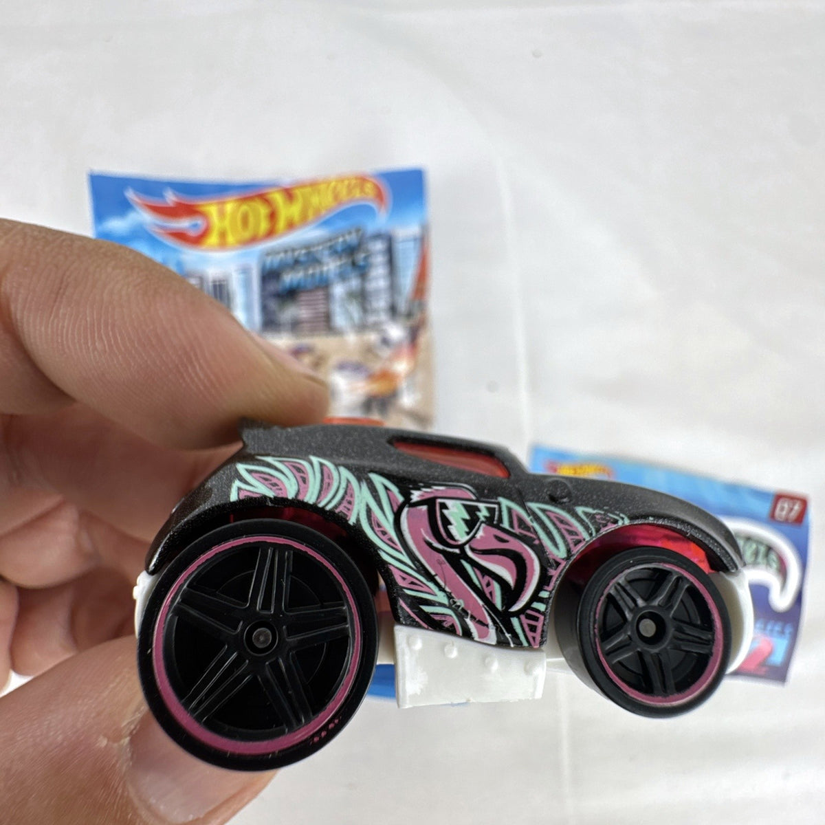 Hot Wheels Rocket Box #07 diecast car in black with pink and teal graphics from Mystery Models Series 2