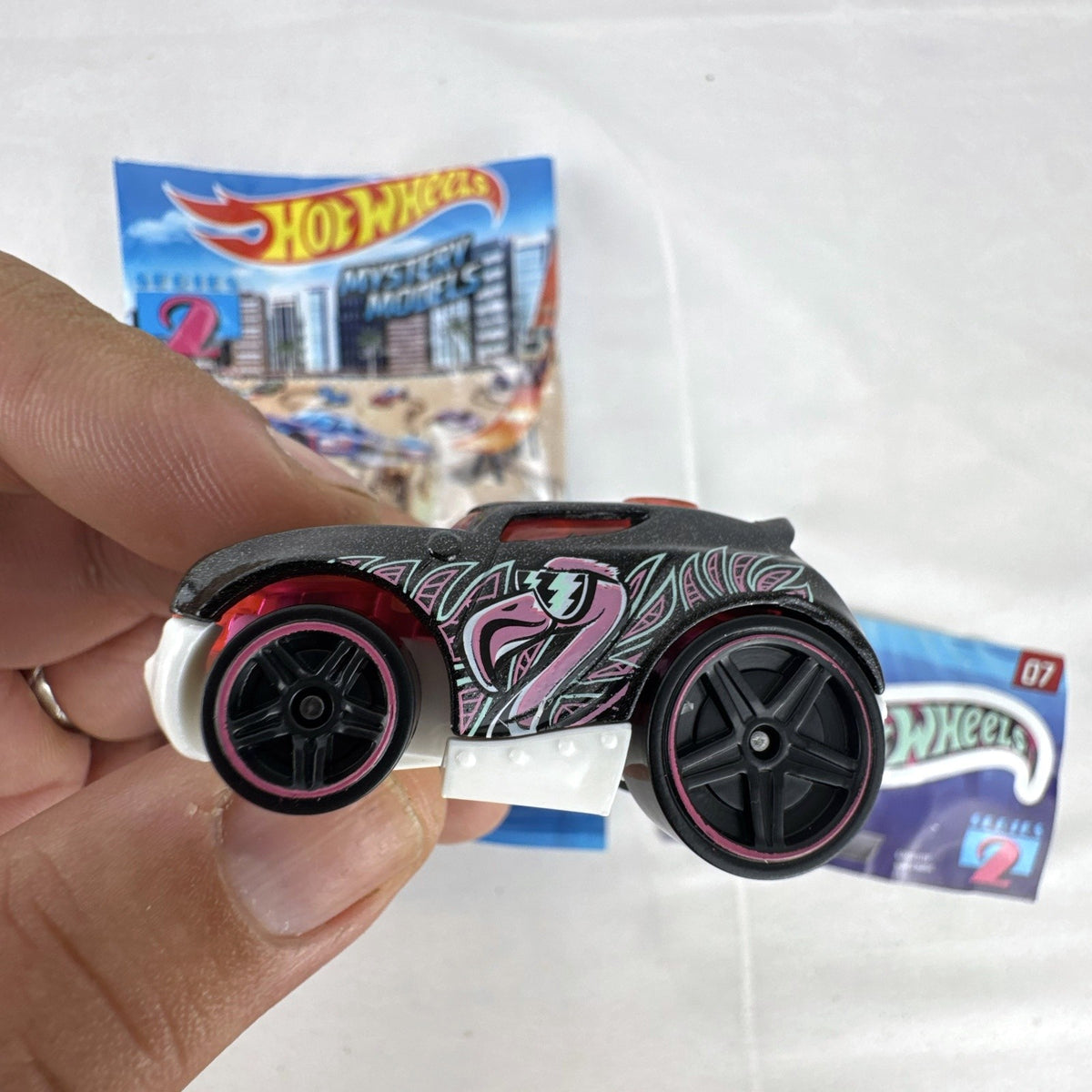 Hot Wheels Rocket Box #07 diecast car in black with pink and teal graphics from Mystery Models Series 2