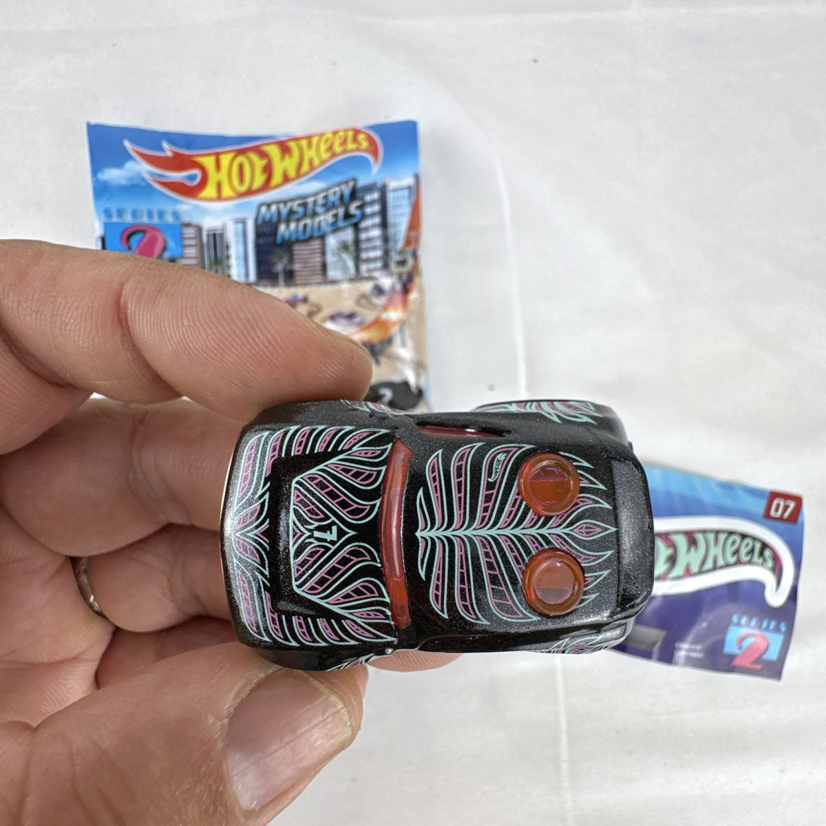 Hot Wheels Rocket Box #07 diecast car in black with pink and teal graphics from Mystery Models Series 2