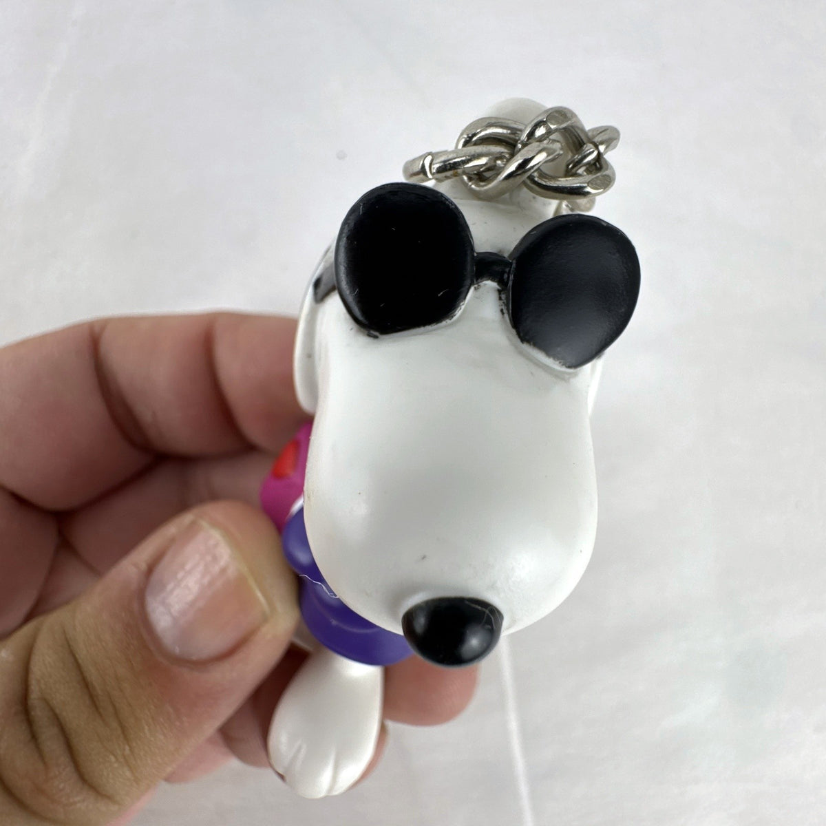Peanuts Snoopy Joe Cool plastic keychain figure with purple sweater, flip-up sunglasses, and Valentine envelope clip.