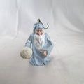 Vintage light blue winter wizard resin Christmas ornament holding a snowball