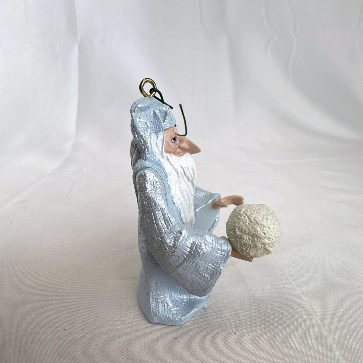 Vintage light blue winter wizard resin Christmas ornament holding a snowball
