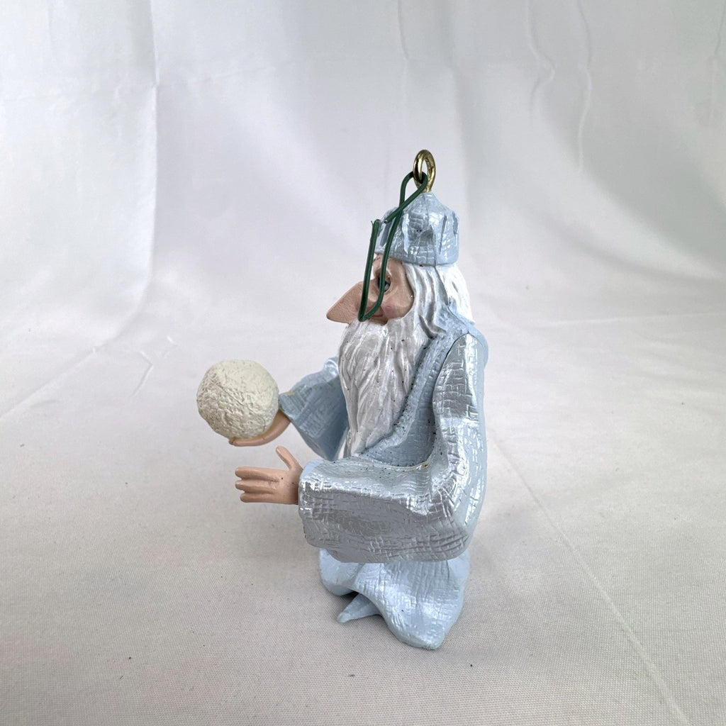 Vintage light blue winter wizard resin Christmas ornament holding a snowball