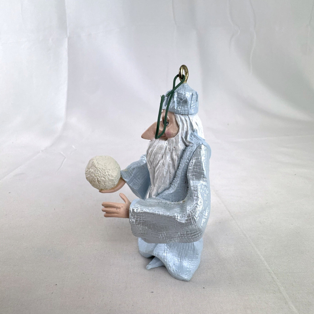 Vintage light blue winter wizard resin Christmas ornament holding a snowball
