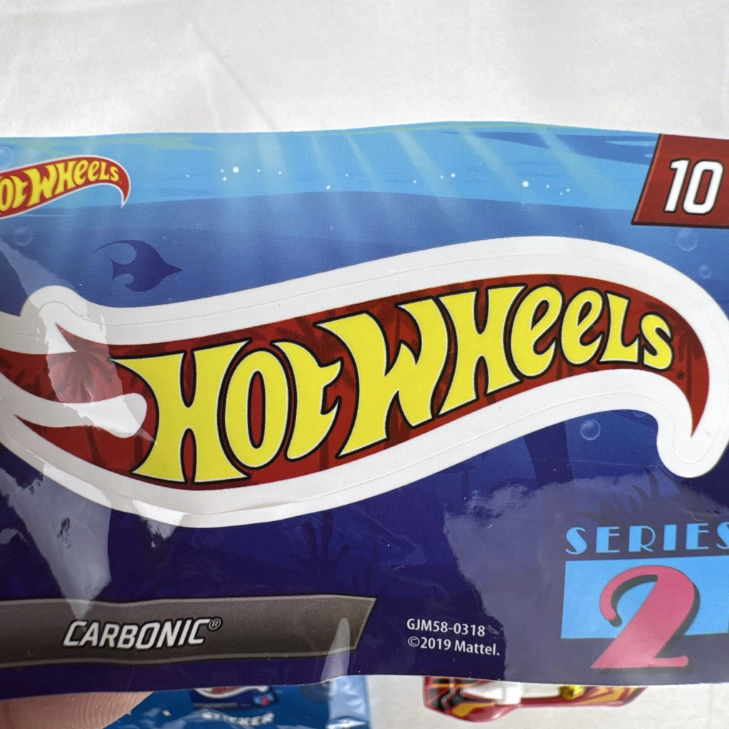 Red Hot Wheels Carbonic 1:64 scale diecast car from Mystery Models Series 2 with yellow graphics and opened foil pouch.