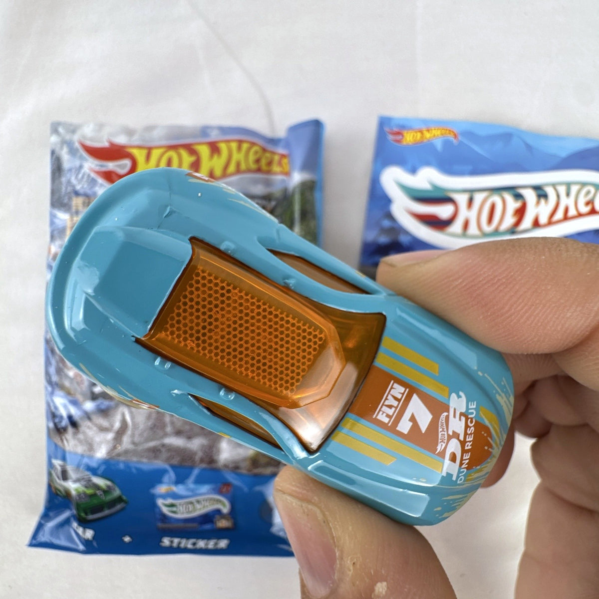 Hot Wheels Fast Master 1:64 scale light blue diecast car with Dune Rescue livery and orange windows