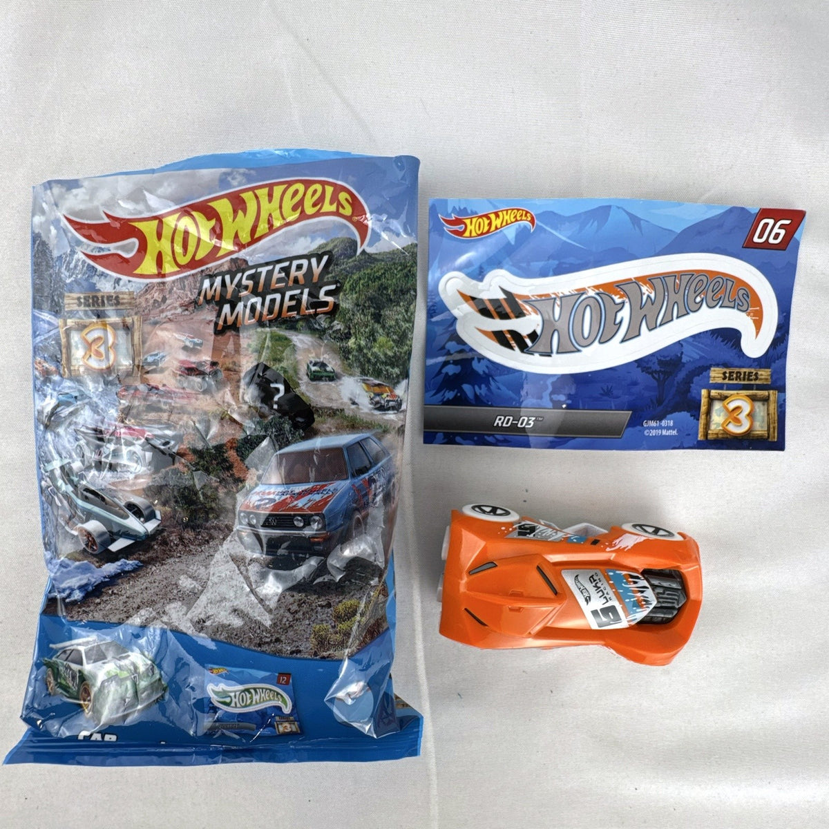 Hot Wheels 1:64 scale RD-03 diecast car in bright orange from Mystery Models Series 3 with original sticker