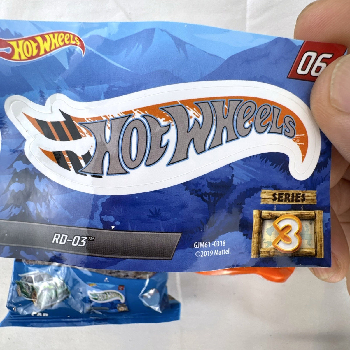 Hot Wheels 1:64 scale RD-03 diecast car in bright orange from Mystery Models Series 3 with original sticker