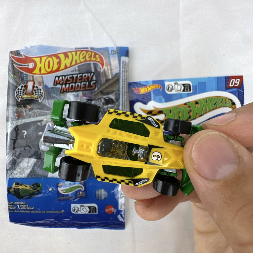Yellow and green Hot Wheels Arrow Dynamic #09 Mystery Models 1:64 scale diecast car with original sticker card.