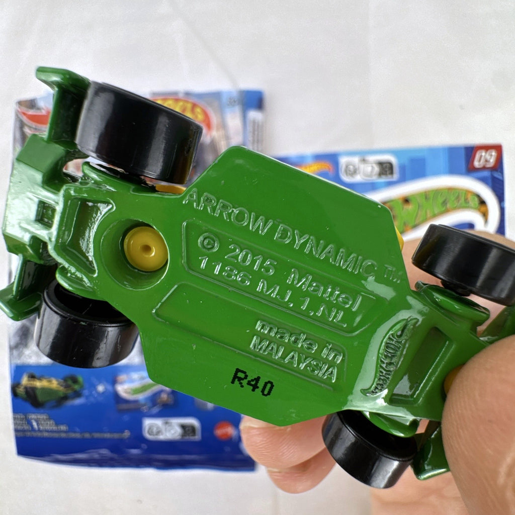 Yellow and green Hot Wheels Arrow Dynamic #09 Mystery Models 1:64 scale diecast car with original sticker card.