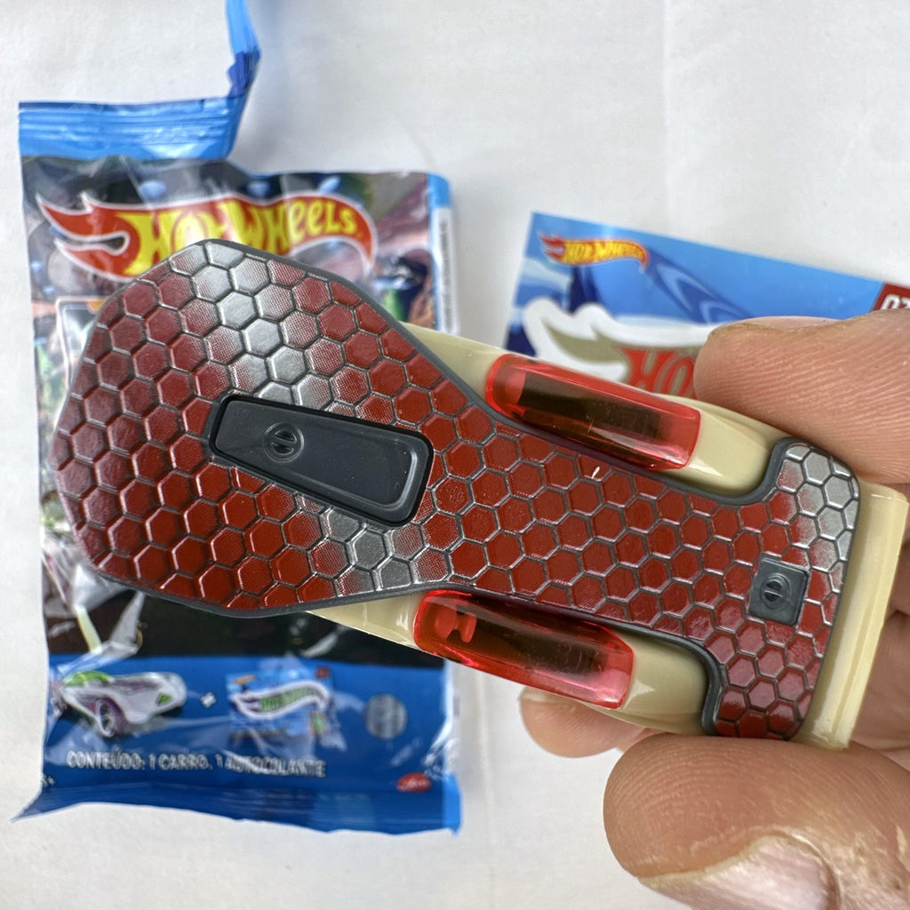 Hot Wheels 1:64 scale Solar Reflex diecast car in tan with red chrome wheels, mystery blind bag, and collector sticker.